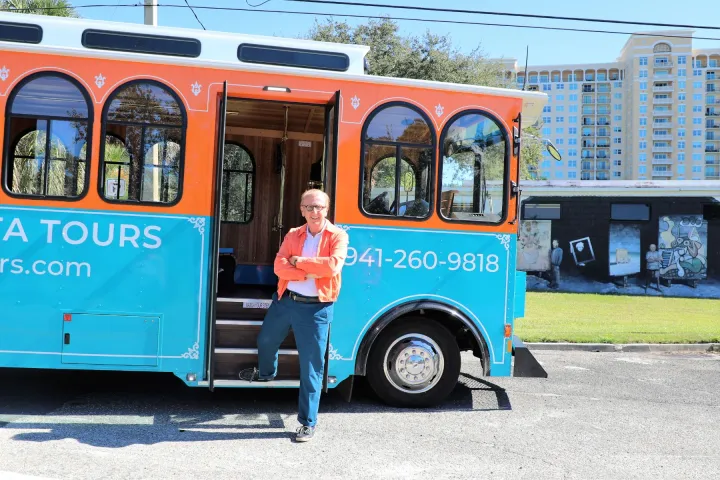 a group of people standing in front of a bus