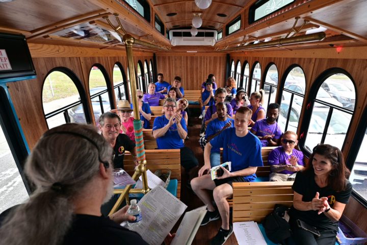 a group of people sitting in trolley as Bob leads Circus Secrets Tour