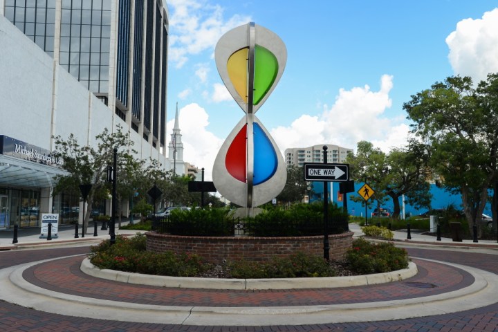 a building that has a sign on the side of a road