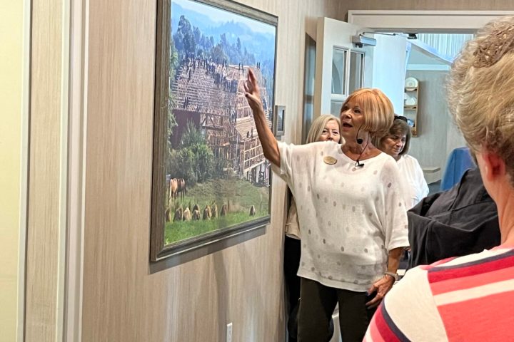 a group of people standing in front of a window