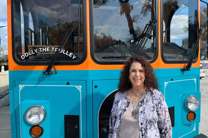 psychic Deni in front of trolley leading tour in Sarasota