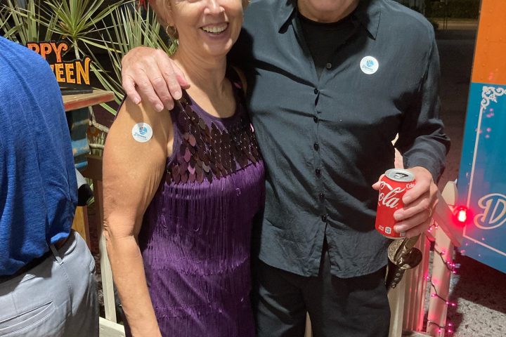 a person holding a sign posing for the camera