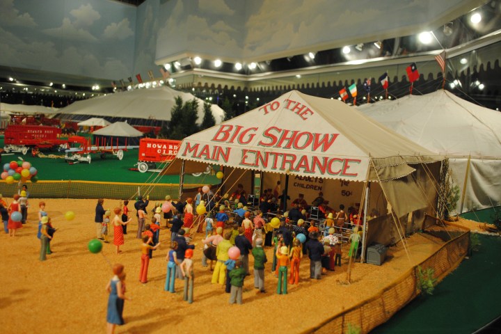 Model of a circus entrance with a crowd and a big tent.