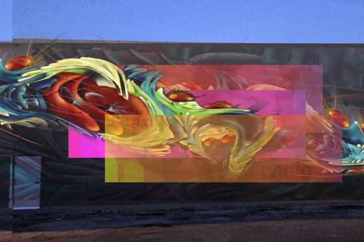 Colorful abstract street art mural on a building wall with overlapping geometric shapes.