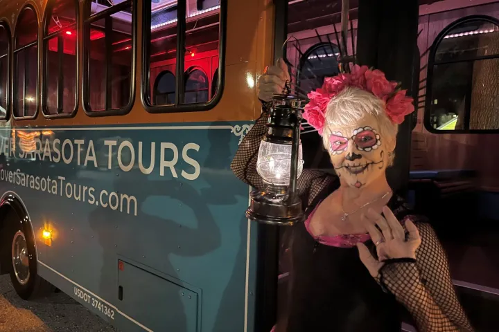 a person standing in front of a bus