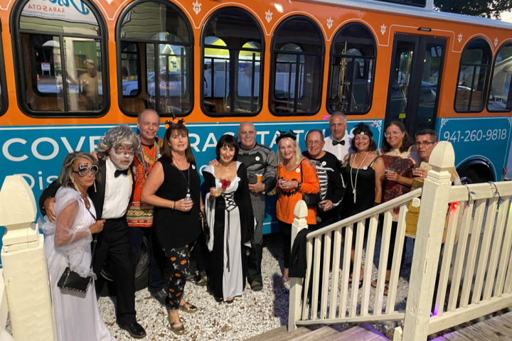 a group of people standing next to a train