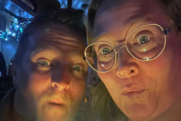 a man and a woman in glasses looking at the camera