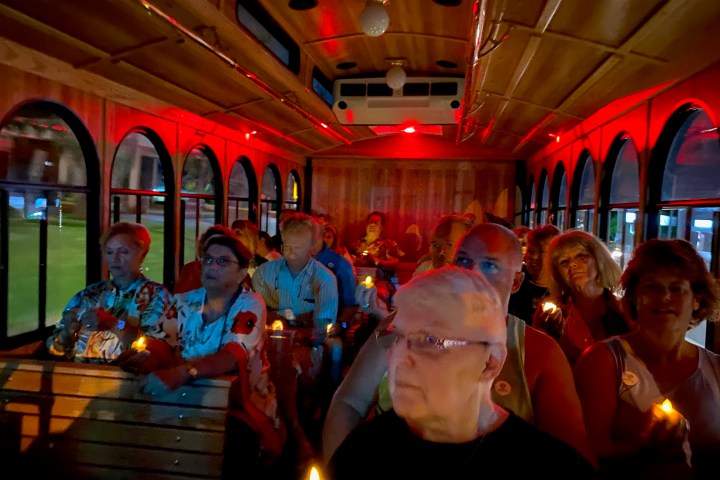a group of people sitting at a table with wine glasses
