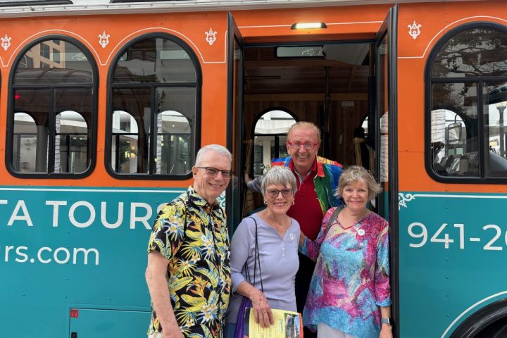 Group of people standing in front of Dolly The Trolley.