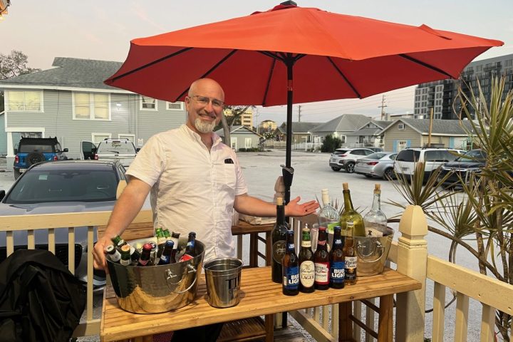 Bartender at Discover Sarasota Tours outdoor tiki bar.