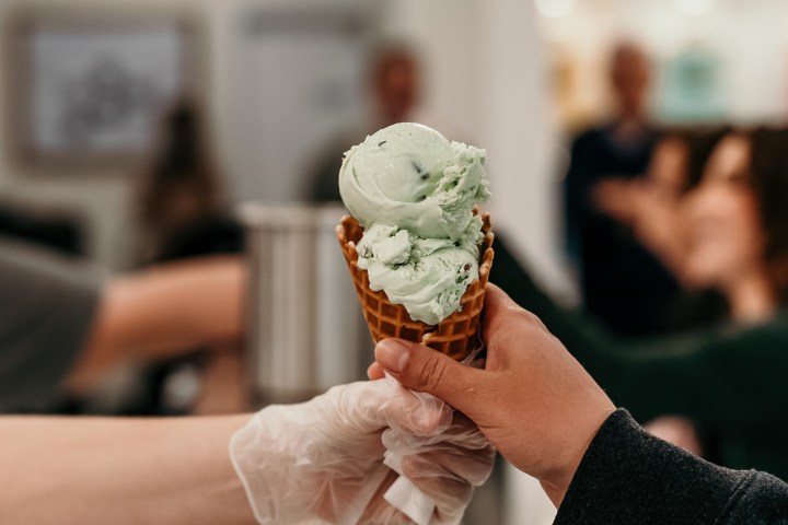 a person holding a piece of food