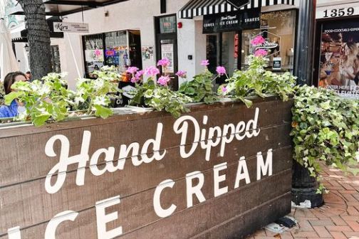 a sign above a store in a brick building