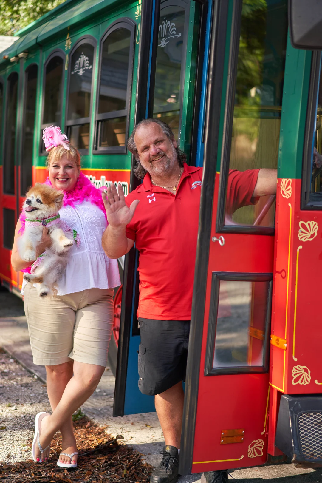 Tammy-and-Siggi_with-Discover-Sarasota-Tours-trolley a person standing in front of a bus