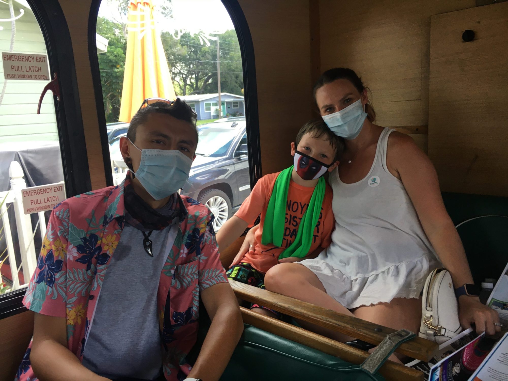 a group of people sitting in a chair talking on a cell phone