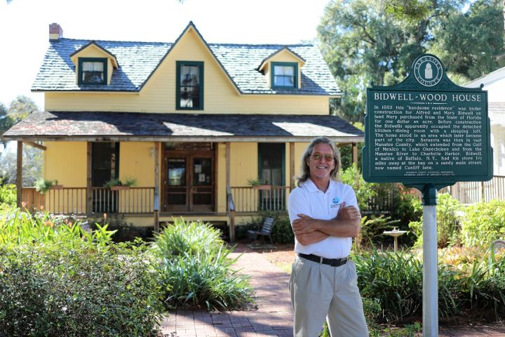 a man standing in front of a house