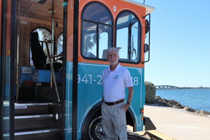 a person standing in front of a bus