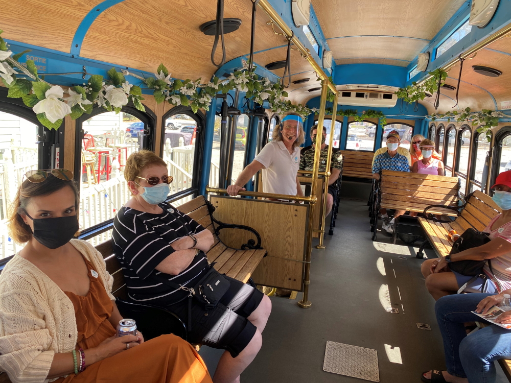 new-trolley-photo-in-masks-01_1000x750 a group of people in a room