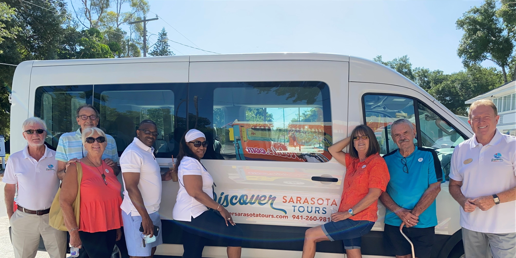 a group of people standing in front of a bus
