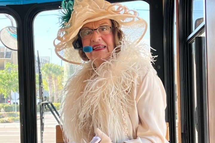 a woman standing in front of a window