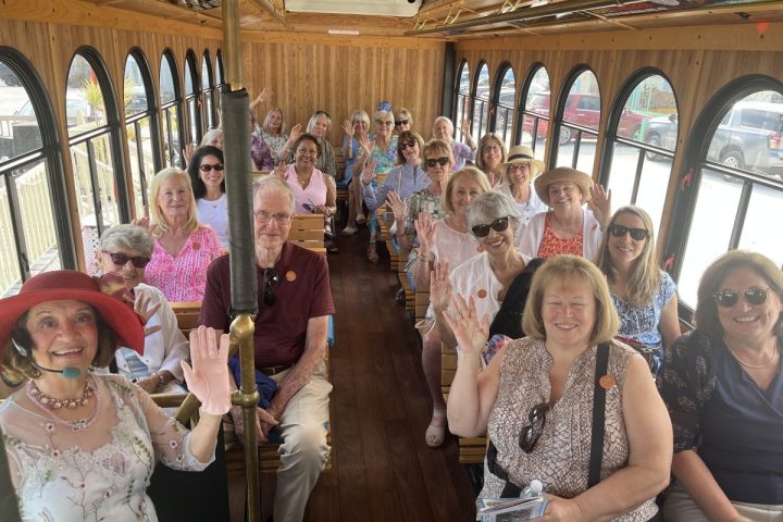 a group of trolly guests posing for the camera on the trolly as part of the leading ladies tour with guide, Kathryn