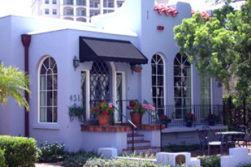 a house with bushes in front of a building
