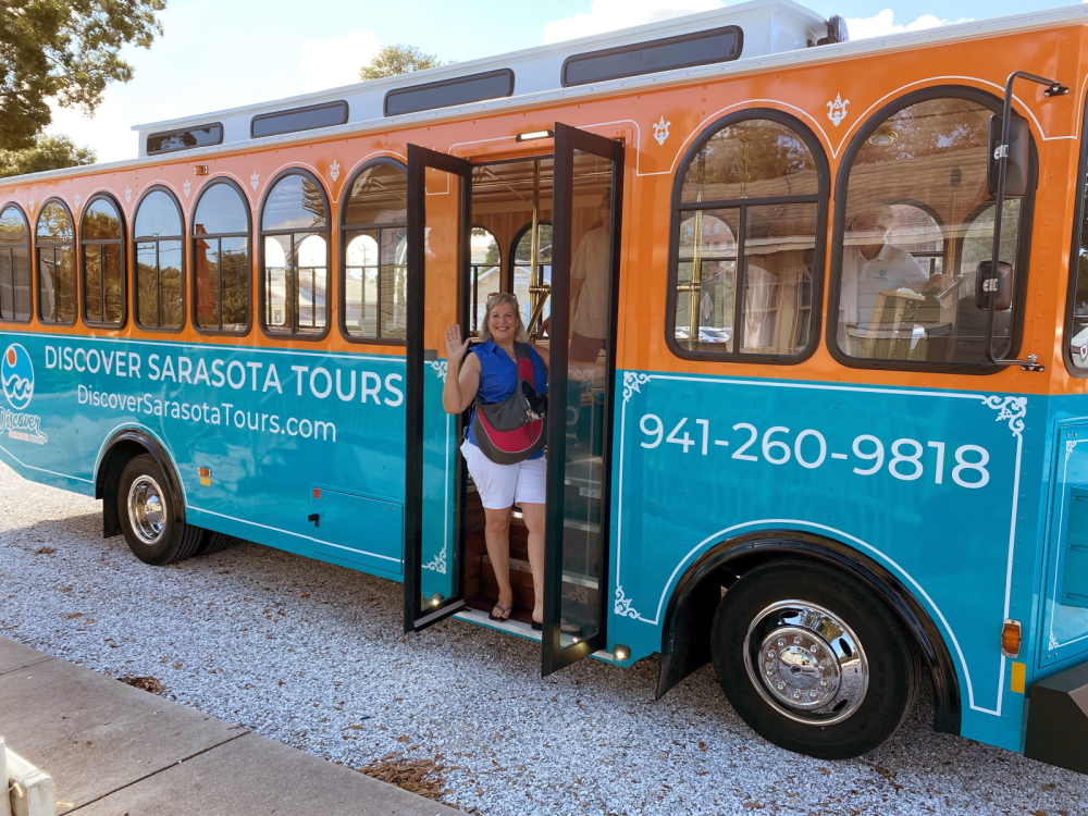 a blue bus parked in a parking lot