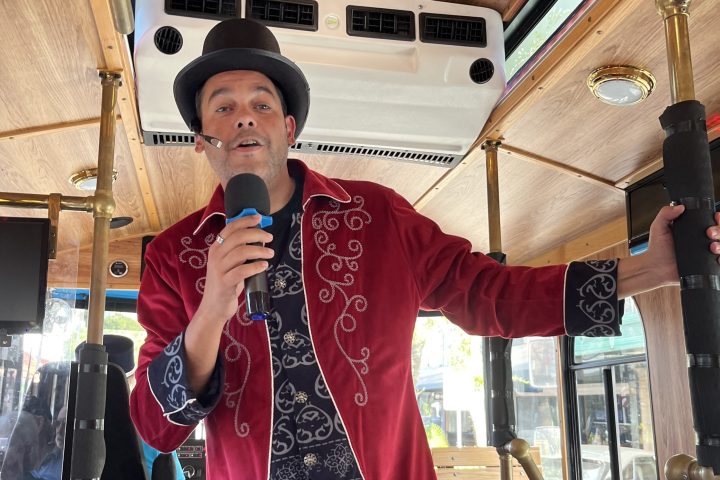 a boy standing in front of a mirror posing for the camera
