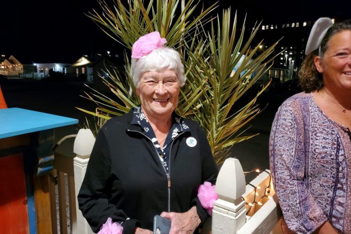 a person standing in front of a group of people posing for the camera