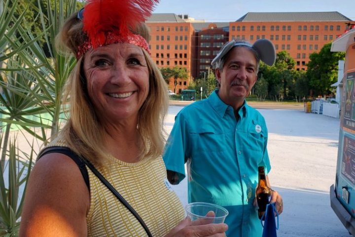 a person holding a sign posing for the camera