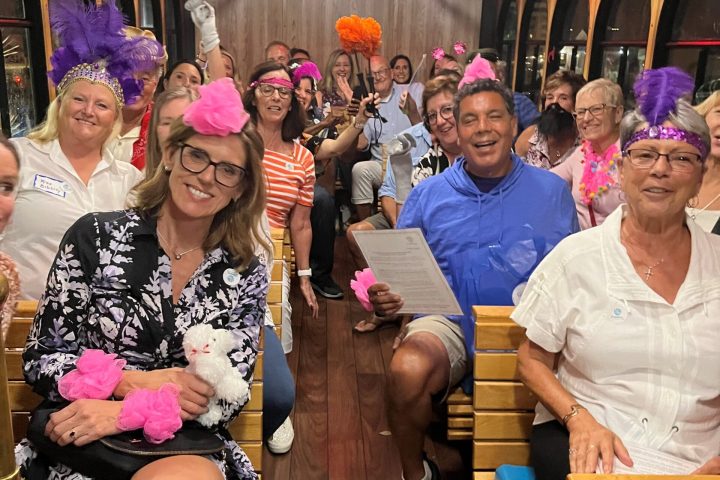 a group of people sitting on a bench posing for the camera