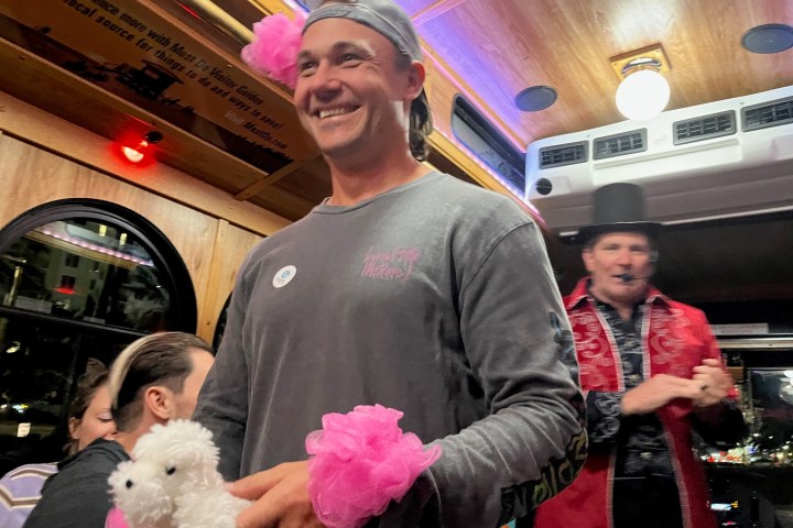 a person standing in front of a stuffed toy posing for the camera