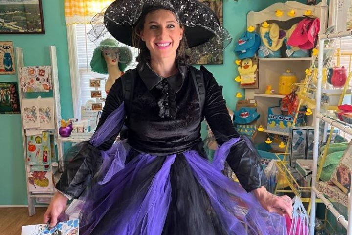 a person wearing a colorful hat standing in front of a store