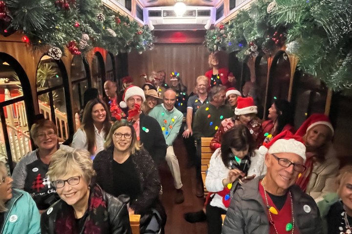 a group of people standing in front of a crowd posing for the camera
