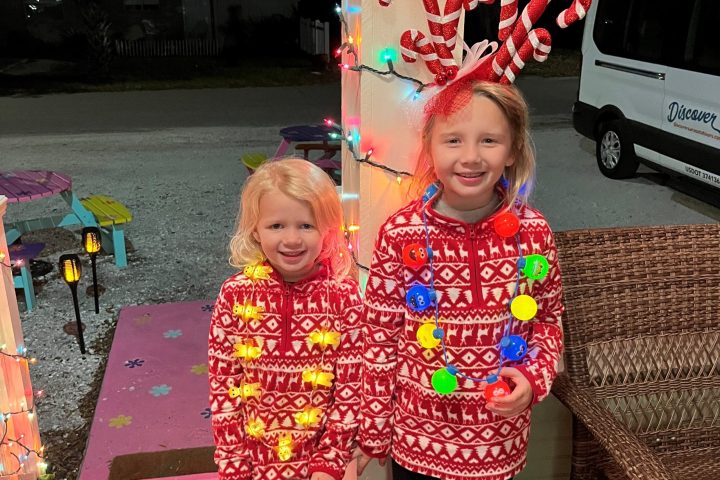 a little girl sitting on a table
