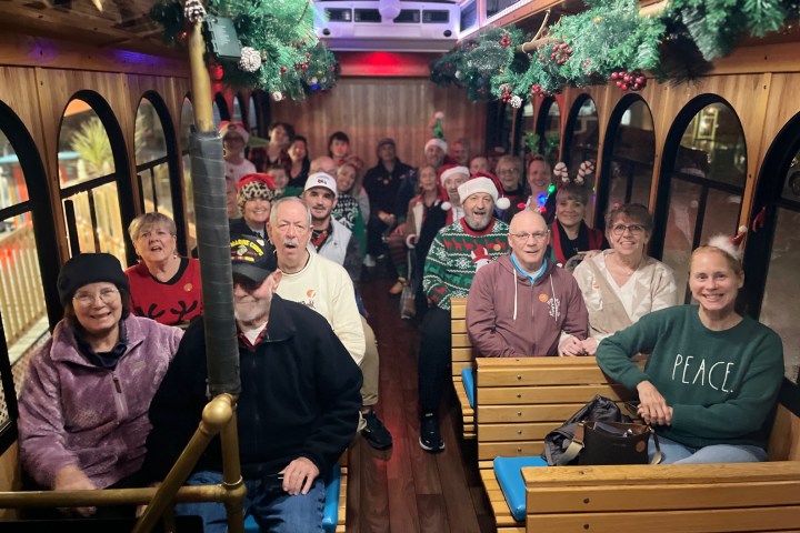 Ray Pilon et al. sitting on a bench posing for the camera