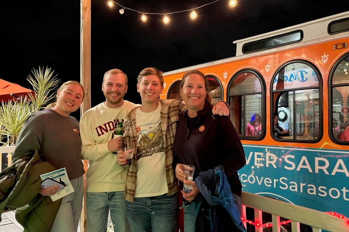 a person standing in front of a group of people posing for the camera