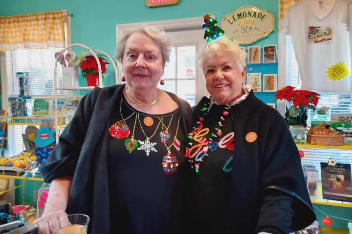 a woman standing in front of a cake