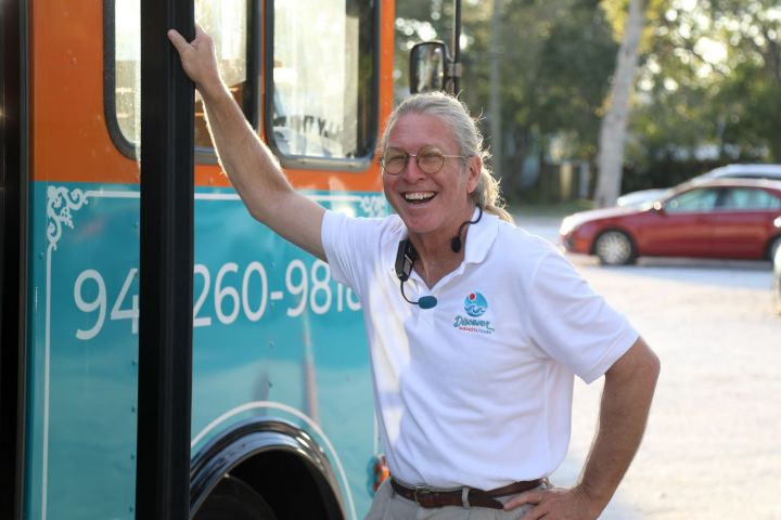 a man standing in front of a car