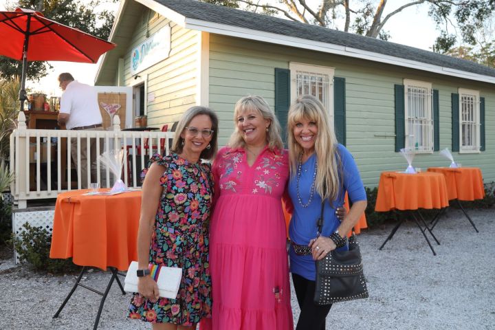 a woman standing in front of a house