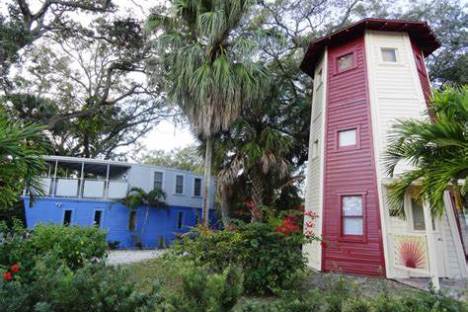 a house with bushes in front of a building