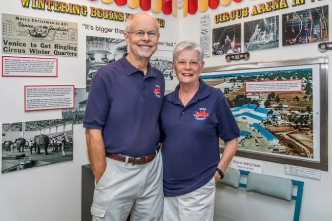 a man standing in front of a sign