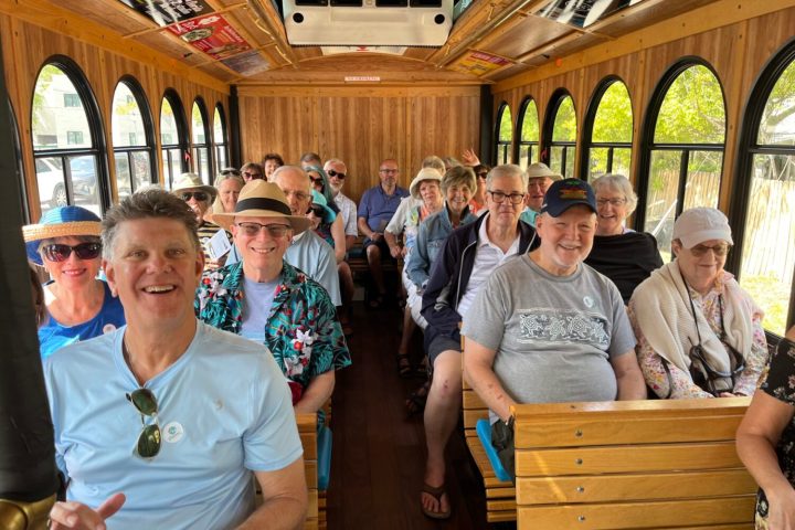a group of people holding wine glasses