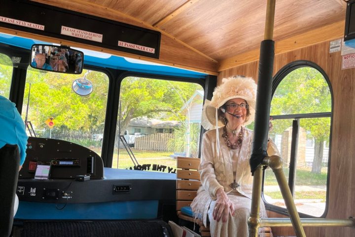 a group of people sitting at a bus stop