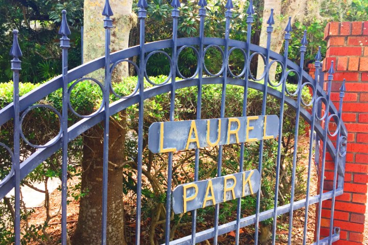 a sign in front of a fence