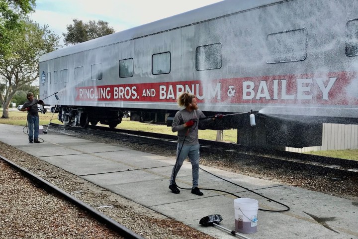 a person standing next to a train