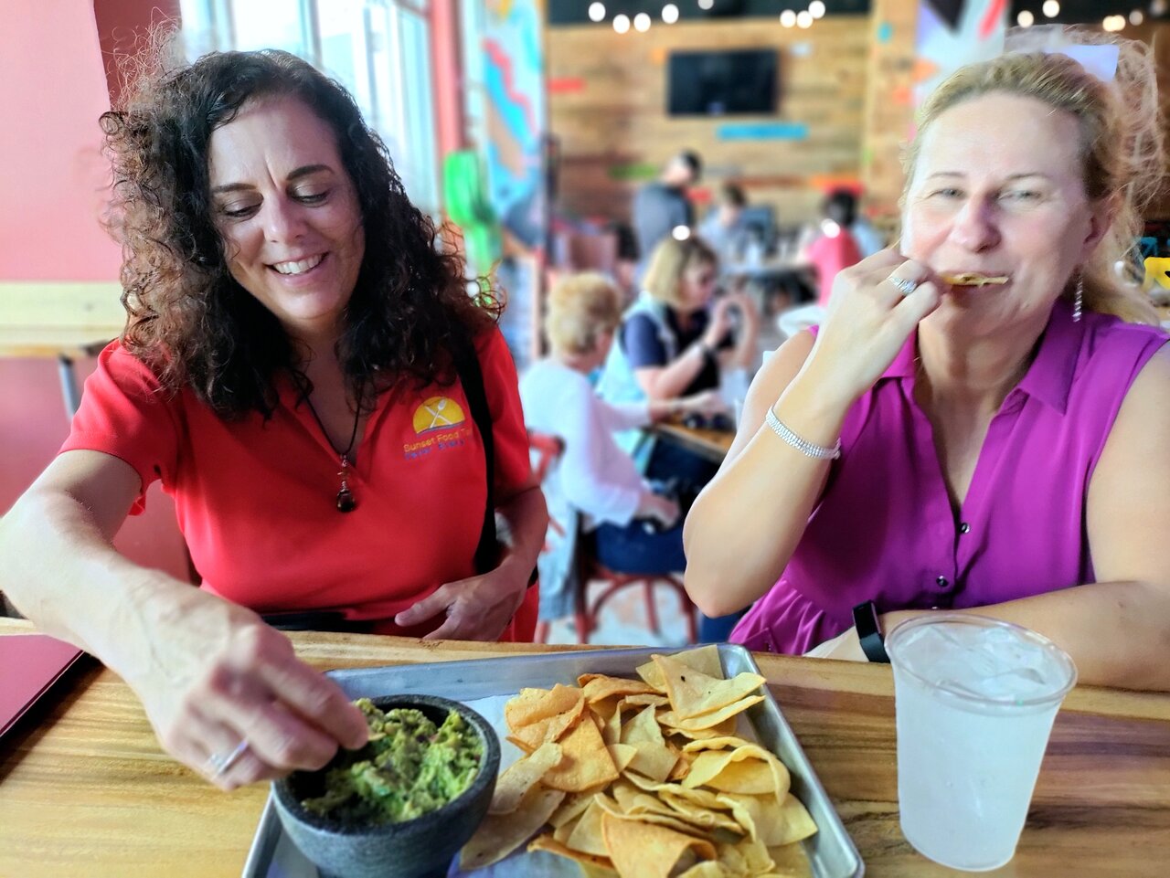 a woman sitting at a table eating food