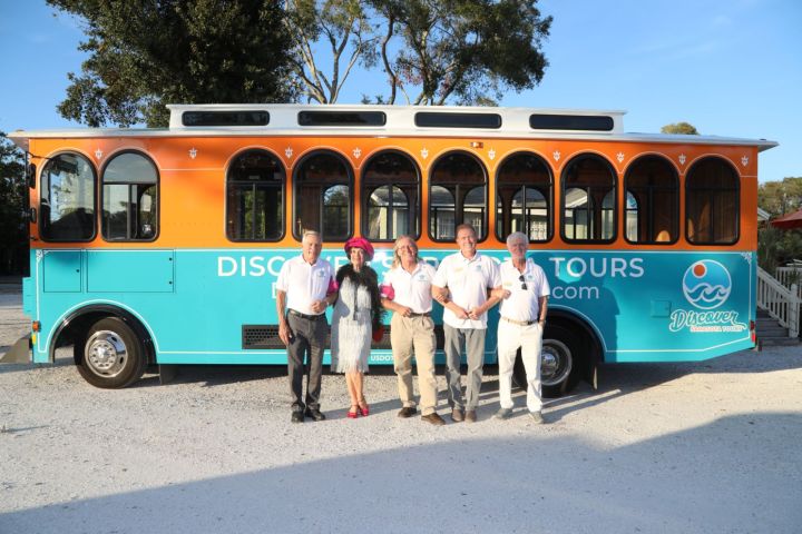 a group of people standing in front of a bus