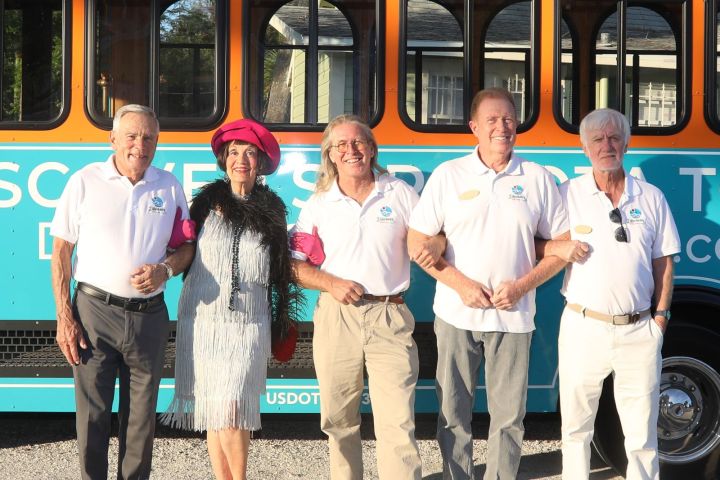 Neil Finn et al. standing in front of a bus