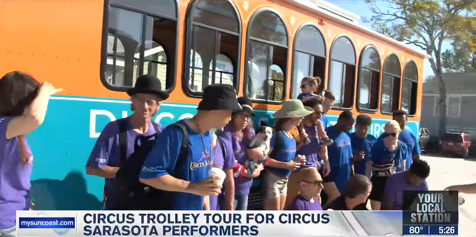 DST-on-ABC7-WWSB_CAC-Circus-Tour_still-from-video_2023-02-26 a group of people standing in front of a bus