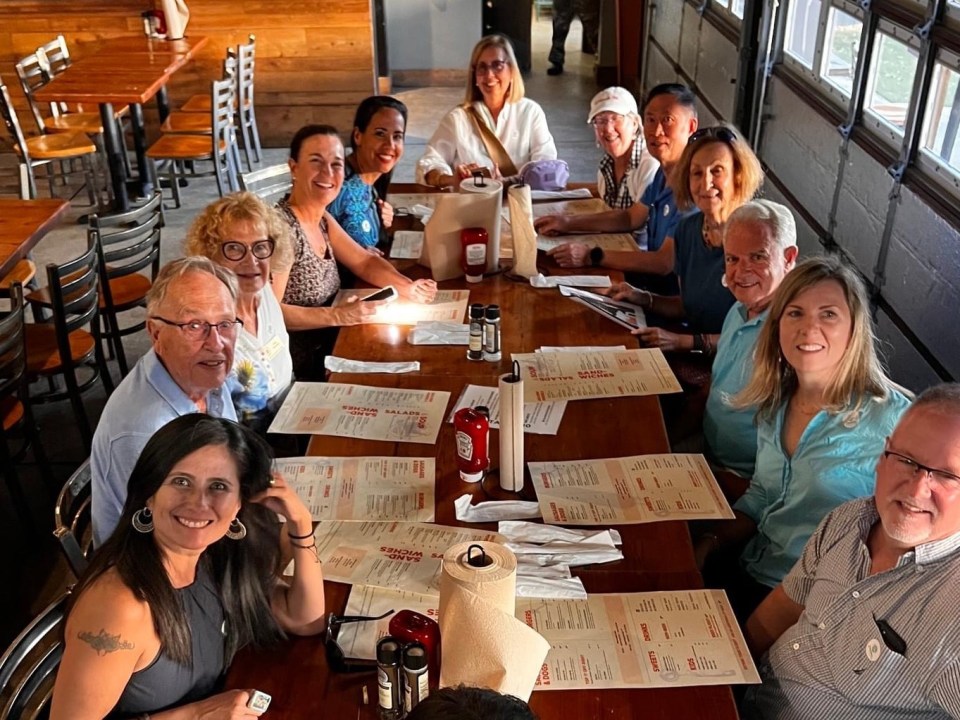 a group of people sitting at a table in a restaurant